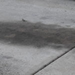 Car,Oil,Leaked,Onto,Concrete,Driveway,Big,Oil,Stain