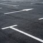 Asphalt,Surface,Of,The,Empty,Parking,With,White,Road,Marking